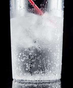 ice and soda in a glass cup - closeup