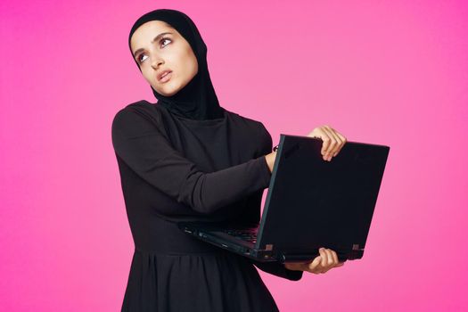 cheerful muslim woman with laptop education student internet technology. High quality photo