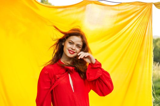 pretty woman in red dress outdoors nature yellow cloth. High quality photo