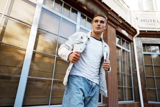 Portrait of handsome young casual man walking on the city street