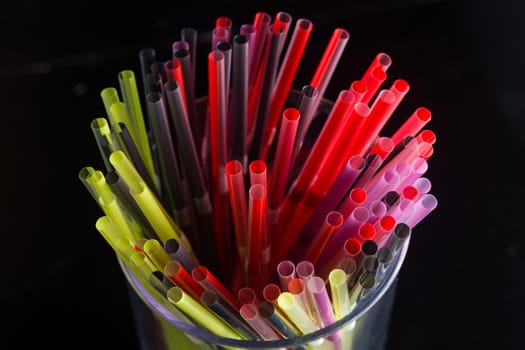 colourful bunch of straw were put in a glass cup