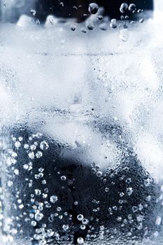 ice and water in a glass cup - closeup