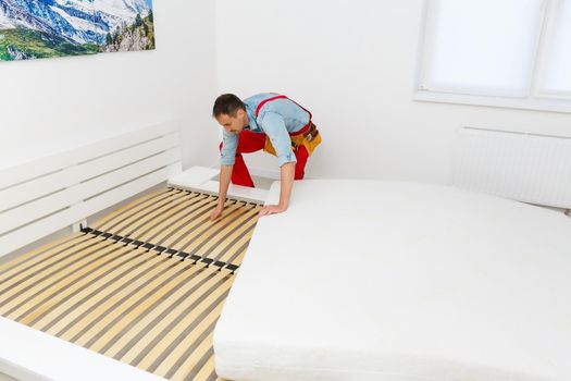 Young male contractor installing furniture at home