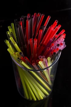 colourful bunch of straw were put in a glass cup