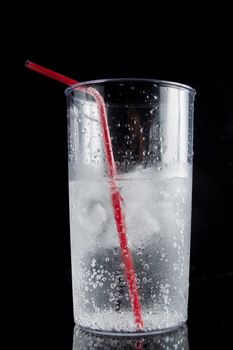 ice and soda in a glass cup - closeup