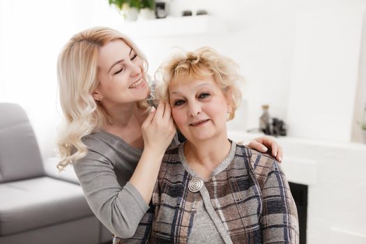 happy senior mother and adult daughter closeup portrait at home