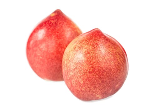 Ripe peaches and leaves on white background