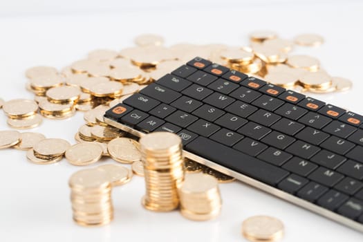 many coins and kebroad on a white background for financal contents