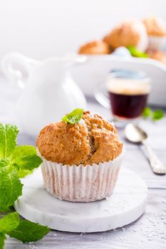 Delicious homemade coconut cinnamon muffin on marble coasters. Healthy food concept.