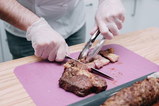 Cooking meat rolls in the cooking class. Beef roll with spices. The process of cutting a roll, close-up.