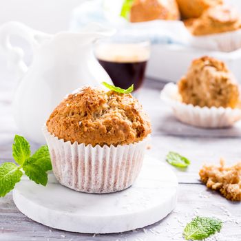 Delicious homemade coconut cinnamon muffin on marble coasters. Healthy food concept.