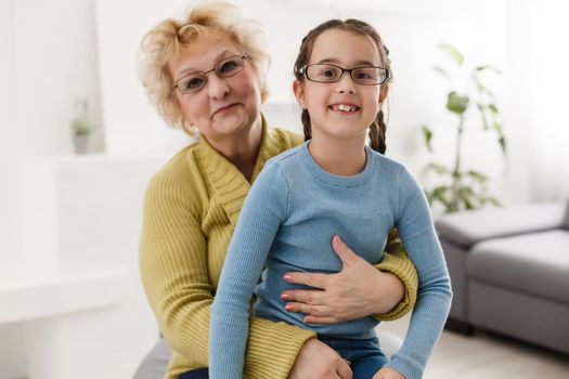 Grandmother and granddaughter portrait, embraced