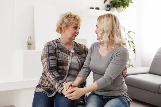 happy senior mother and adult daughter closeup portrait at home