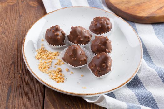 Small chocolate sweets with nuts close up. Dessert