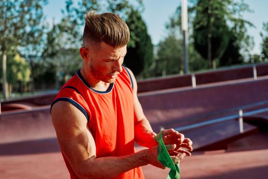 athletic man in red jersey workout exercise pumped up body. High quality photo