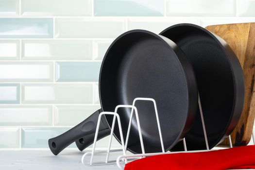 Clean and dry cooking pans on a kitchen counter. Close up.