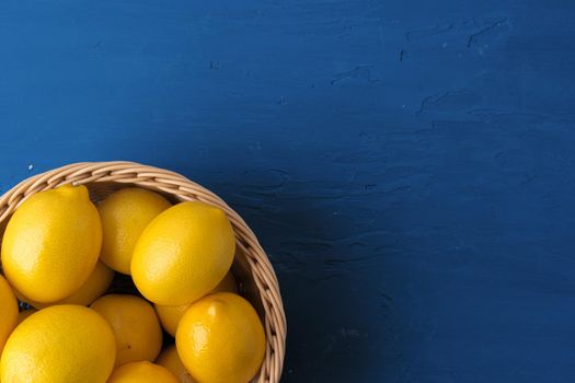 Lemon on classic blue background, top view. Close up.