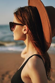 cheerful woman in sunglasses Sandy coast landscape sun. High quality photo