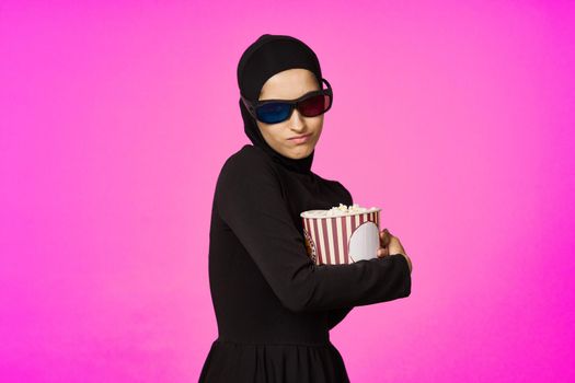 Muslim woman entertainment cinema popcorn fashion isolated background. High quality photo