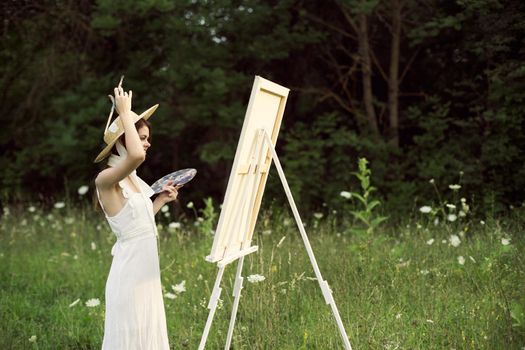 cheerful woman outdoors drawing art landscape hobby. High quality photo