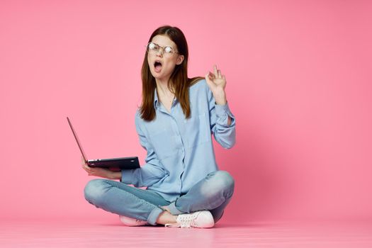 woman with laptop sitting on the floor internet online technology shopping. High quality photo