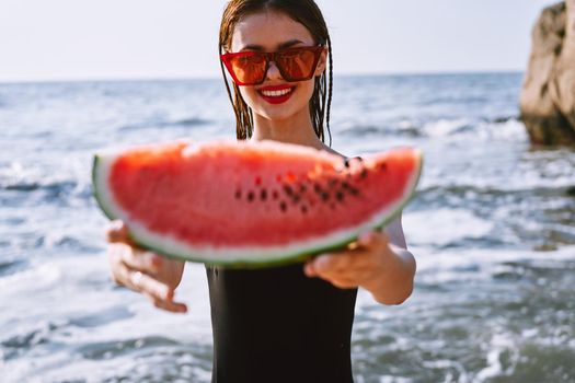 cheerful pretty woman in black swimsuit watermelon fashion travel. High quality photo