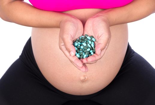 pregnant woman with pack of pills in her hands isolated on white background