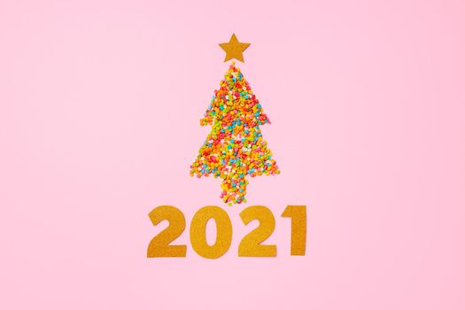 Christmas tree made of colorful confetti flat lay top view