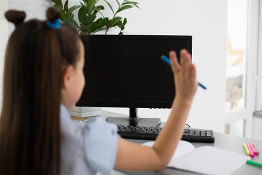 Pretty stylish schoolgirl studying homework math during her online lesson at home, social distance during quarantine, self-isolation, online education concept, home schooler