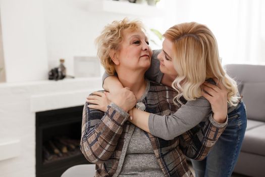 happy senior mother and adult daughter closeup portrait at home