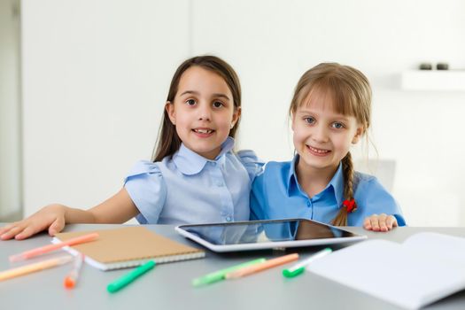 Pretty stylish schoolgirls studying during her online lesson at home, social distance during quarantine, self-isolation, online education concept