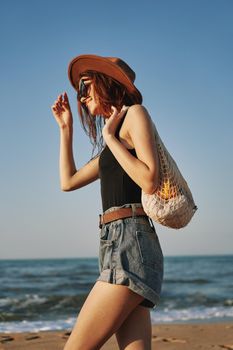 woman walking on the beach landscape sun fun lifestyle. High quality photo