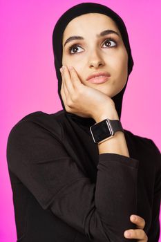 muslim woman in black hijab smart watch technology entertainment. High quality photo