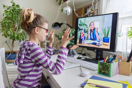 Online learning, children, little student girl learning language remotely with an English teacher. E-education, modern technologies in education, school concept