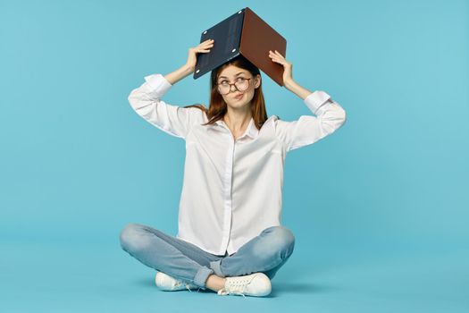 woman with laptop learning internet online education blue background. High quality photo