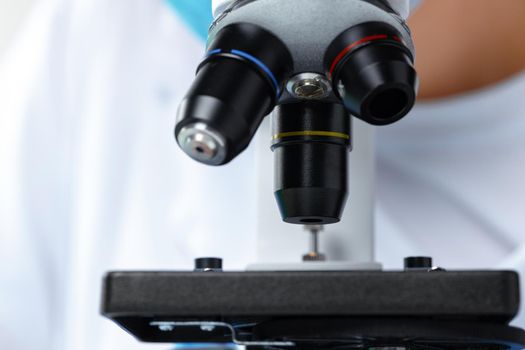 Mo0dern white laboratory microscope on white background, close up