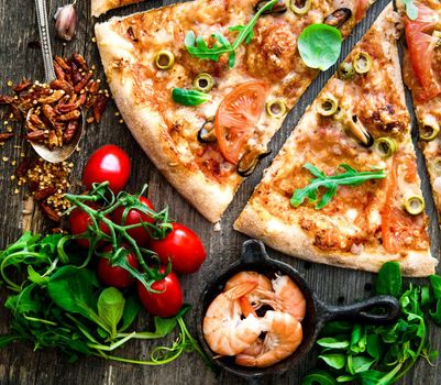 Tasty seafood pizza with cherries on a wooden table