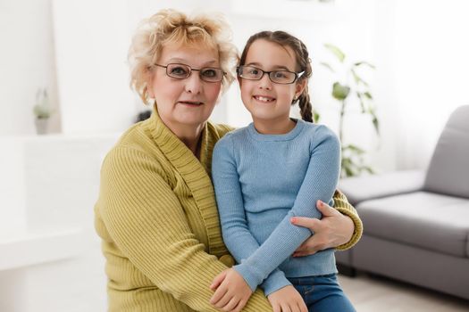 grandmother with granddaughter wearing glasses both