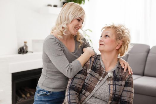 happy senior mother and adult daughter closeup portrait at home