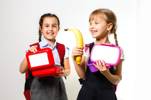 Two little schoolgirls. Education, fashion, friendship concept.