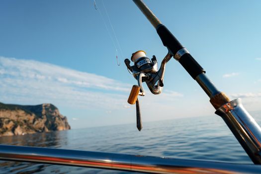 Fishing rod on a sailboat in open sea, close up photo