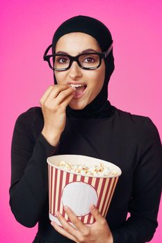 Muslim woman attractive look popcorn glasses movie watching isolated background. High quality photo