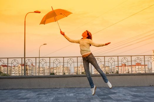 The girl is flying with an umbrella