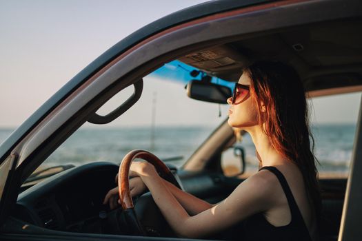 pretty woman in sunglasses driving a car trip. High quality photo