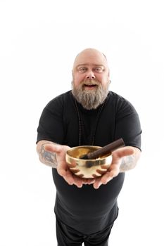 Funn caucasian bearded tattoed man is posing on white background