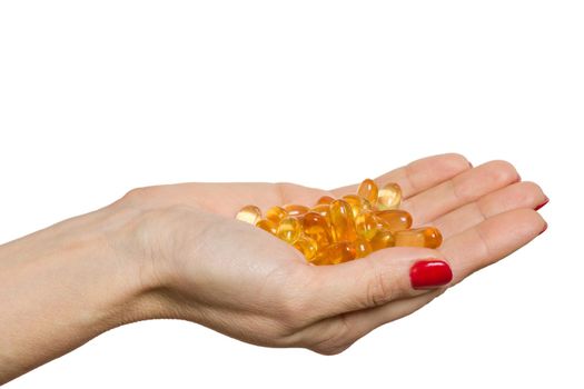 Isolated hand holding capsule of Omega 3 on white background.