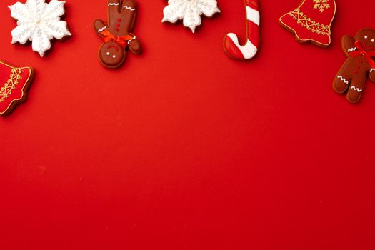 Christmas gingerbread cookies on red background top view, copy space