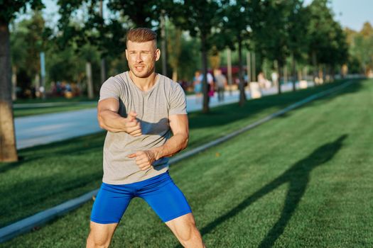 athletic man in the park workout jogging exercise summer. High quality photo