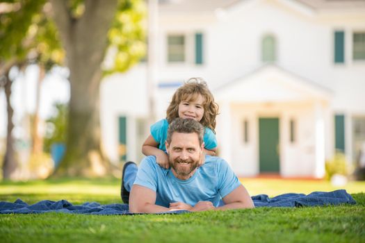 dad with kid on summer day. parenting and fatherhood. fathers day. happy father and son having fun outdoor. family value. childhood and parenthood. parent relax with little child boy on grass.