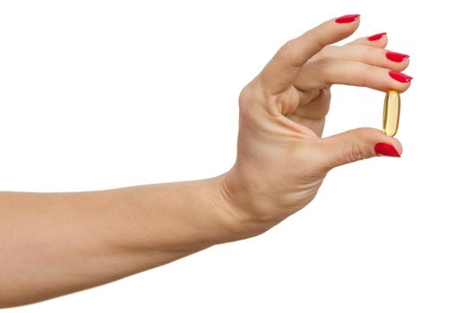 Isolated hand holding capsule of Omega 3 on white background.